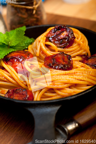 Image of italian spaghetti pasta and tomato with mint leaves 
