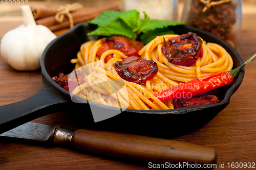 Image of italian spaghetti pasta and tomato with mint leaves 