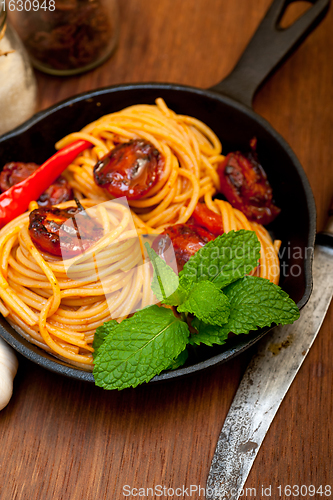 Image of italian spaghetti pasta and tomato with mint leaves 