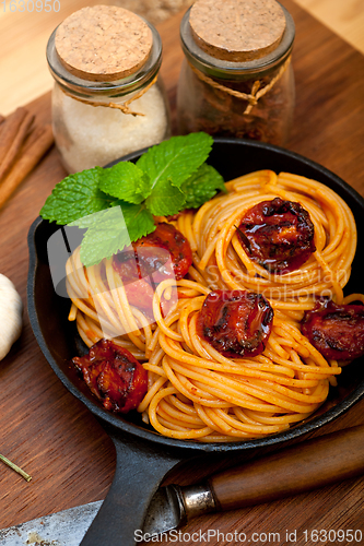 Image of italian spaghetti pasta and tomato with mint leaves 