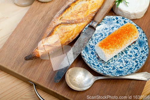 Image of French cheese and fresh  baguette on a wood cutter