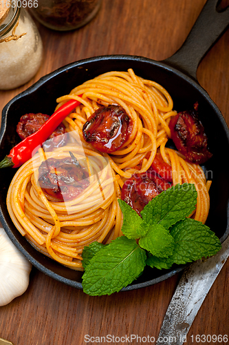 Image of italian spaghetti pasta and tomato with mint leaves 