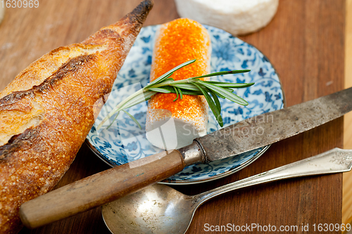 Image of French cheese and fresh  baguette on a wood cutter