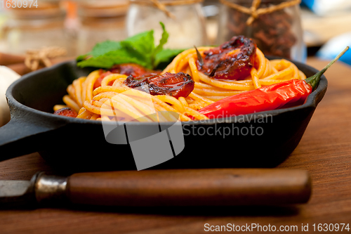 Image of italian spaghetti pasta and tomato with mint leaves 