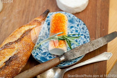 Image of French cheese and fresh  baguette on a wood cutter