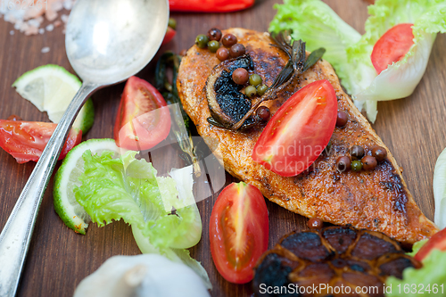 Image of wood fired hoven cooked chicken breast on wood board 