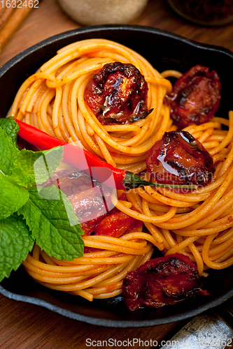 Image of italian spaghetti pasta and tomato with mint leaves 
