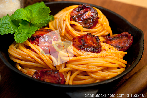 Image of italian spaghetti pasta and tomato with mint leaves 