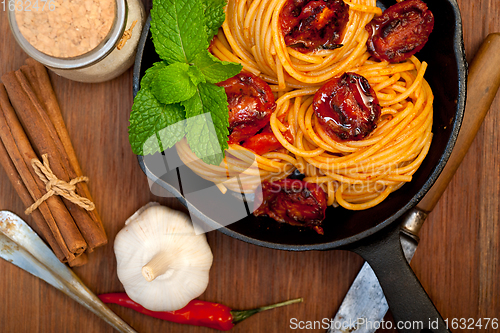 Image of italian spaghetti pasta and tomato with mint leaves 