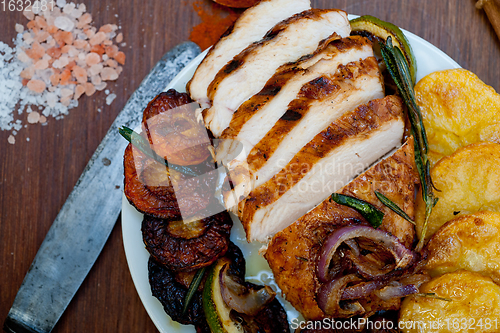 Image of roasted grilled BBQ chicken breast with herbs and spices 