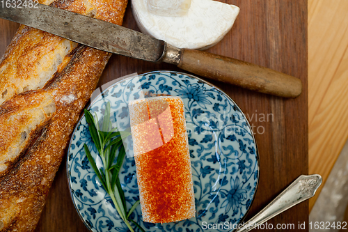 Image of French cheese and fresh  baguette on a wood cutter