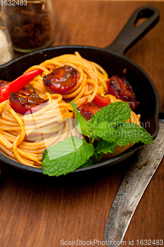 Image of italian spaghetti pasta and tomato with mint leaves 