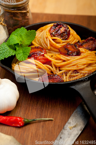 Image of italian spaghetti pasta and tomato with mint leaves 