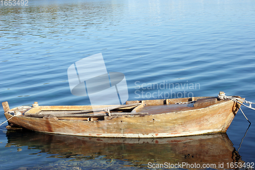 Image of A wooden rowing boat tide down