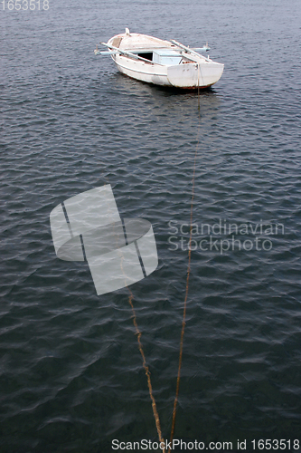 Image of A wooden rowing boat tide down