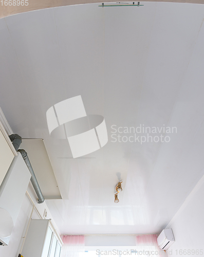 Image of Ceiling made of white plastic panels in the interior of the kitchen