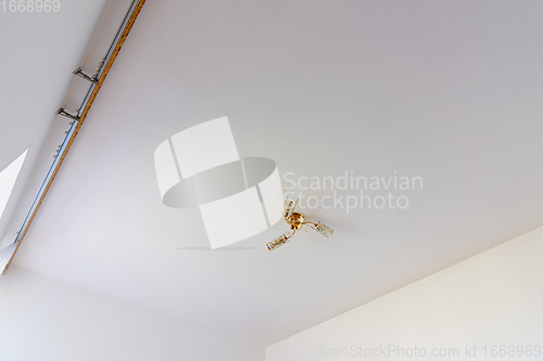 Image of Plastered and white painted ceiling in the interior of the room