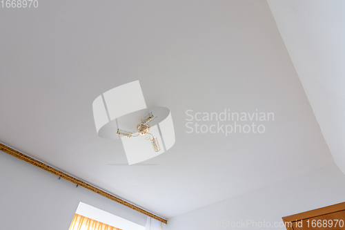 Image of Plastered and white painted ceiling in the bedroom