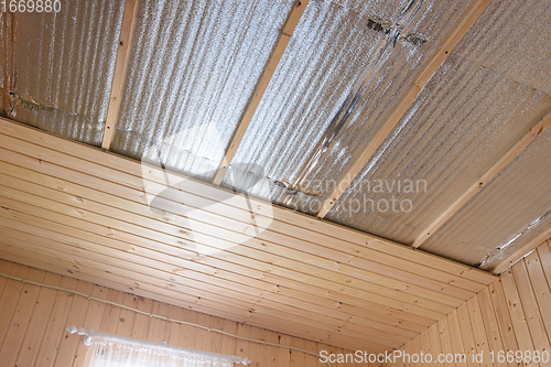 Image of Stage of finishing clapboard ceiling in a country house