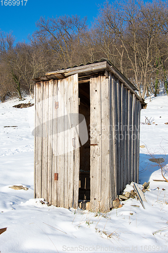 Image of Old wooden outdoor toilet in winter weather
