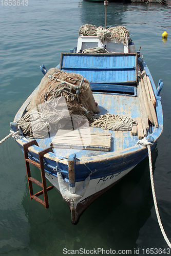 Image of A wooden rowing boat tide down