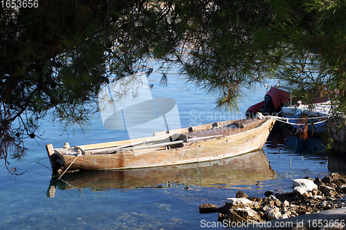 Image of A wooden rowing boat tide down