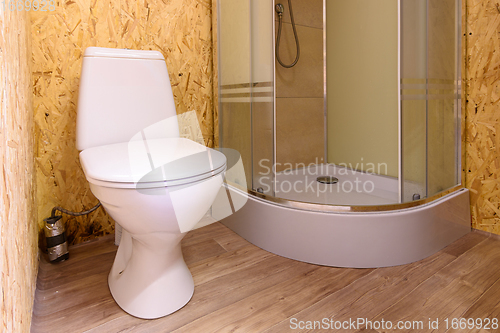 Image of Bathroom in a wooden house, toilet and shower