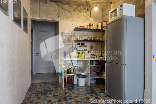 Image of The interior of the living room combined with a kitchen without renovation with a temporary kitchen set