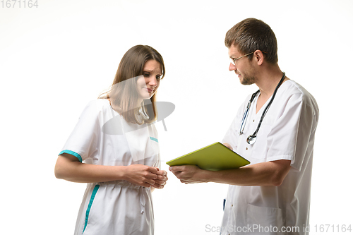 Image of The head of the department shows the doctor the error in the diagnosis of the patient