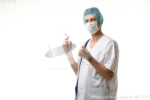 Image of Surgeon holds a syringe in his hands and looked into the frame, isolated on white background