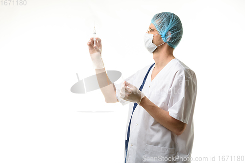 Image of Surgeon holds a syringe in his hands and releases air bubbles from it, isolated on white background