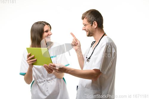 Image of Two doctors have fun discussing information on a tablet