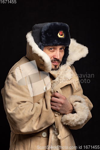 Image of Portrait of a frozen man of Caucasian appearance in a Soviet officer\'s fur hat and an army sheepskin coat