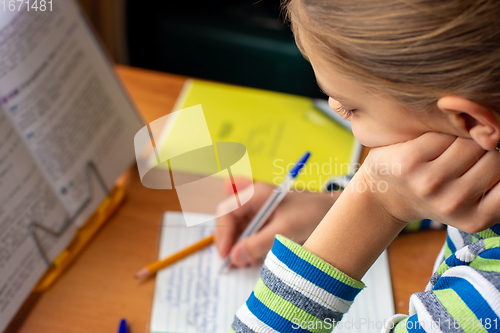Image of Close-up of a girl doing homework