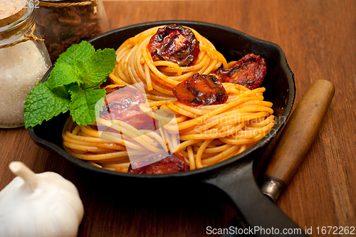 Image of italian spaghetti pasta and tomato with mint leaves 