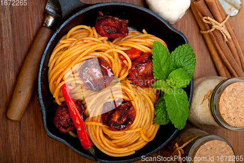Image of italian spaghetti pasta and tomato with mint leaves 