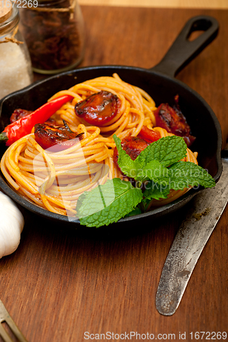 Image of italian spaghetti pasta and tomato with mint leaves 