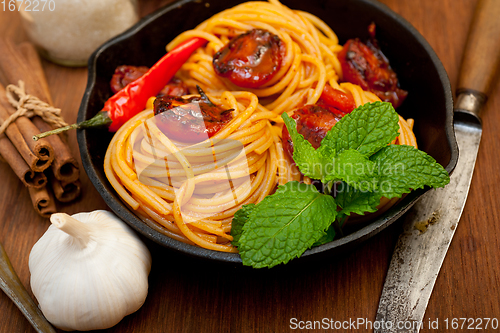 Image of italian spaghetti pasta and tomato with mint leaves 