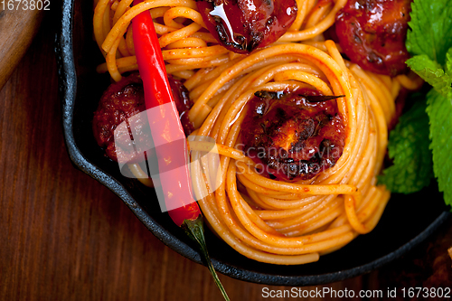 Image of italian spaghetti pasta and tomato with mint leaves 