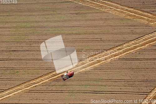 Image of Combine harvester working in the fields