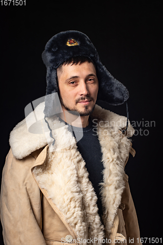 Image of Portrait of a man of thirty years of Caucasian appearance in a Soviet officer\'s fur hat and an army sheepskin coat