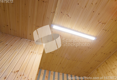 Image of View of a ceiling from a wooden lining with an included LED daylight lamp