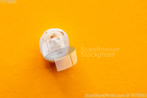 Image of Human tooth root affected by caries, close-up on yellow background