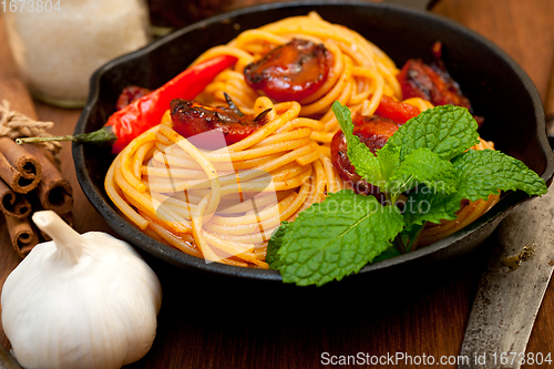 Image of italian spaghetti pasta and tomato with mint leaves 