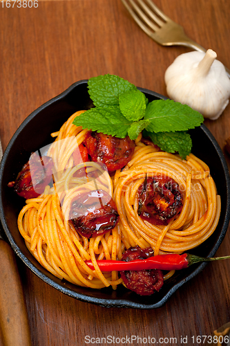 Image of italian spaghetti pasta and tomato with mint leaves 