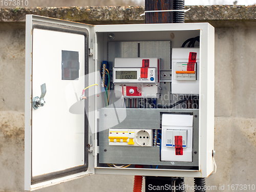 Image of Introductory machine and electric energy meter in a dashboard on a pole on a land plot