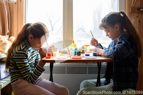 Image of Children at home at the table make crafts and gifts for the holiday