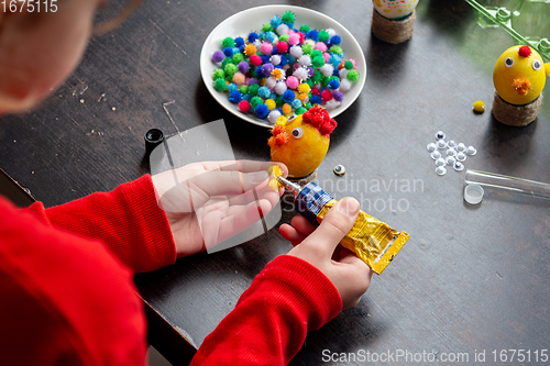 Image of a girl in the workshop makes crafts from eggs for the Easter holiday