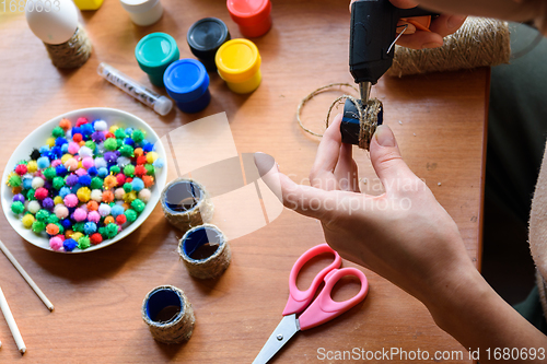 Image of The girl\'s hands make crafts with a rut pistol