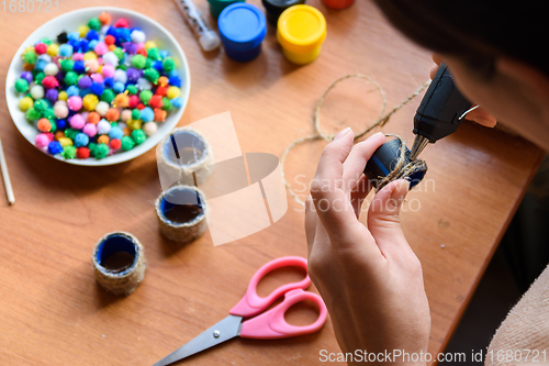 Image of Girl\'s hands decorate elements with a glue gun